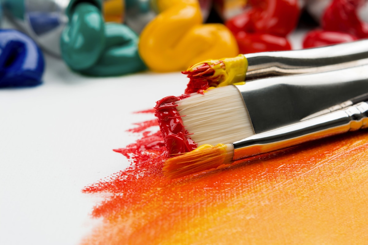 Paint brushes and bright pigment in a studio